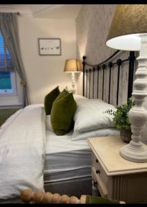 a bedroom with two beds and a table with a lamp at Bewerley Hall farm in Harrogate +12 photos