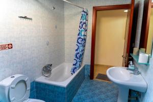 a bathroom with a toilet and a tub and a sink at Dina Apartments in Fanari +13 photos