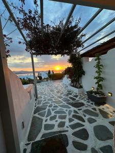 a view of a patio with a sunset in the background at Egea House in Stelida