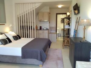 a bedroom with a large bed and a kitchen at Villa Adelais in Tsoukaladhes +12 photos