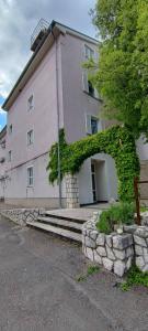 a building with ivy growing on the side of it at Maris in Novi Vinodolski