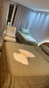 two beds in a room with pillows on them at Hoa Beach Flats Tamandaré - 210 in Tamandaré