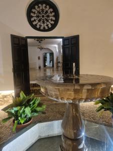 a fountain in the middle of a room at Alquería de Tajarja in Tajarja +8 photos