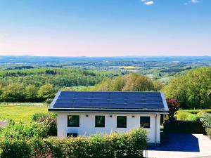 a house with solar panels on the roof at Ferienhaus Auszeit in Laubach
