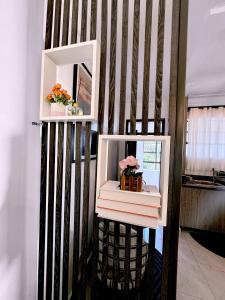 a shelf with books and a mirror on a wall at The Home Kololo in Kampala +10 photos