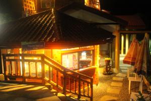 a small building with a roof on a street at Twin Hearts Resort Pool Cabin 2 in Jasaan