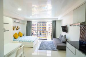 a living room with a bed and a couch at The Urban Tropical Apartments in Mai Khao Beach +132 photos