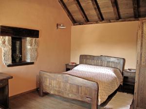 a bedroom with a bed with a wooden headboard at Stone House Pojata in Starigrad-Paklenica +20 photos