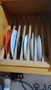 a row of knives sitting on a wooden shelf at Agora House for men only 仅限男性 in Alexandria