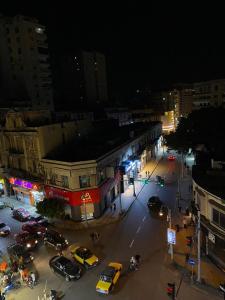 a city street at night with cars parked on the street at Agora House for men only 仅限男性 in Alexandria