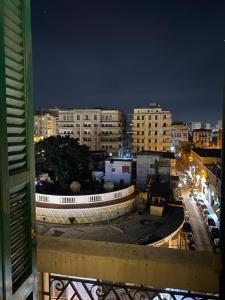 a view of a city at night with buildings at Agora House for men only 仅限男性 in Alexandria