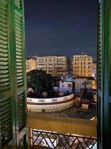 a view from a window of a city at night at Agora House for men only 仅限男性 in Alexandria +35 photos
