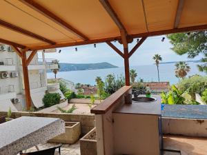 a patio with a view of the water at Petrovic house in Herceg-Novi