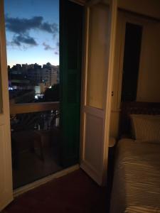 a room with a bed and a window with a view at Agora House for men only 仅限男性 in Alexandria