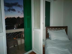 a bedroom with a bed and a window with a view at Agora House for men only 仅限男性 in Alexandria