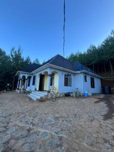 a house being constructed with a stone driveway at Jegestal Serenity Homestay Camping and Tours in Lushoto
