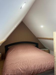 a bedroom with a bed in a attic at La datcha in Drouvin-les-Marais +2 photos