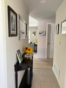 a hallway with a table with a vase of flowers on it at 1 bedroom In a quiet neighborhood near the Main Street- Room A in Rowland Heights
