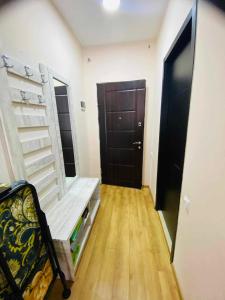 a room with a hallway with a door and a wooden floor at Salome in Itʼkhvisi