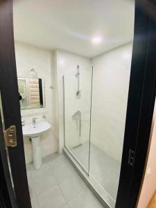 a bathroom with a shower and a sink at Salome in Itʼkhvisi