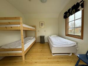 a bedroom with two bunk beds and a window at Möja Värdshus in Möja