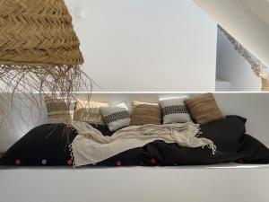 a bed with pillows on the floor in a room at Casa Zita Verde - Ibiza style villa with sea view & sunset BBQ in Cala Llonga +46 photos