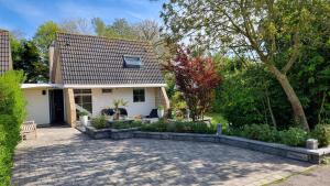 a house with a patio in front of it at Lake House 74, luxury accommodation ir Sauna in Warmond