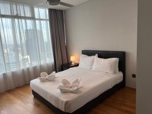 Ένα ή περισσότερα κρεβάτια σε δωμάτιο στο Vortex Residence KLCC Bukit Bintang Kuala Lumpur