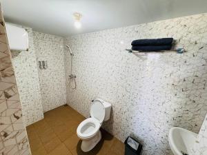 a bathroom with a toilet and a sink at RDA BATURITI VILLA bali in Baturiti +3 photos