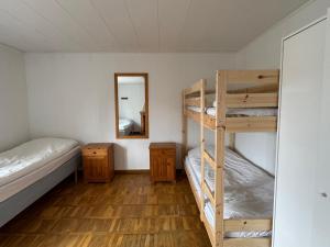 a room with two bunk beds and a mirror at Möja Värdshus in Möja +15 photos