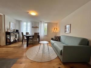 a living room with a couch and a table at Klara 1031 - Olma, Spital, Uni St- Gallen in St. Gallen
