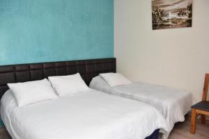 Postel nebo postele na pokoji v ubytování Hotel L'Initiale