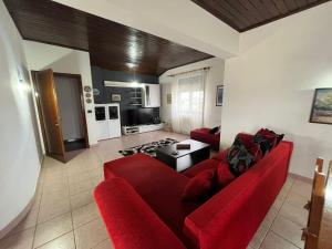 a living room with a red couch and a table at Vila 202 in Durrës