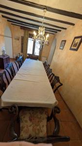 a large dining room with a long table and chairs at Casa Rural Casaplana, grupos grandes, 1500m2 de casa, piscina privada y patio, 2 barbacoas, Zona Prepirineo in Calasanz +141 photos