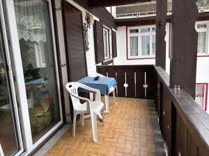 a patio with a table and two chairs on a porch at Casa Rizzi in Campitello di Fassa +4 photos