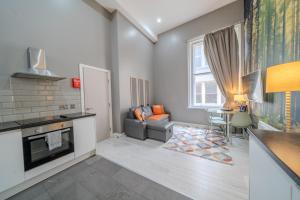 a kitchen and living room with a couch and a table at Align Lux Apartments, Liverpool City Centre in Liverpool +104 photos