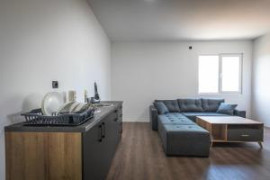 a living room with a couch and a table at Rivi Apartments in Mrzenci
