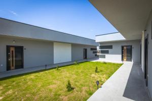 an external view of a building with a yard at Rivi Apartments in Mrzenci