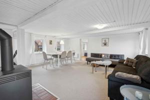 a living room with a couch and a table at Cozy Holiday Home Near Lillebælt in Haderslev