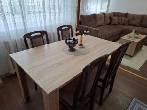 a wooden dining room table with chairs and a couch at ReLaX in Kula