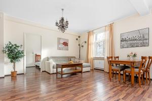 a living room with a couch and a table at Compass apartment in Tallinn