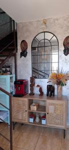 a wooden cabinet with a mirror on a wall at Casa Adriana in Eforie Sud