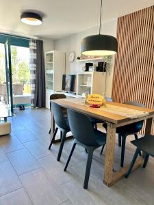 a dining room with a wooden table and chairs at 7034 Enseling in Dahme