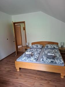 a bedroom with two beds and a door to a hallway at House Mara in Korenica