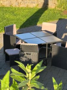 a picnic table and chairs on a patio at Apartment Montabaur Heiligenroth in Heiligenroth +5 photos