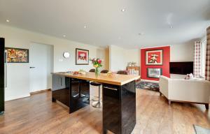 a kitchen and living room with a table and a couch at The Studio Cottage in Alnwick