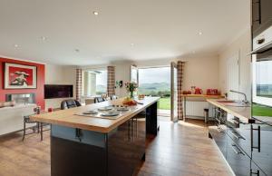 a kitchen with a large island in a room at The Studio Cottage in Alnwick