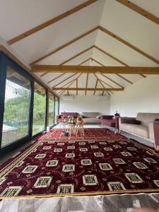 a living room with a large rug on the floor at Villa Lux Nature in Sarajevo