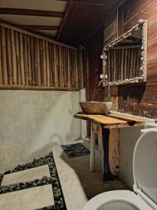 a bathroom with a sink and a toilet at Yellow Coco Gili Gede in Gili Gede