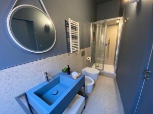 a bathroom with a blue sink and a mirror at Le Tre Gemme - Luxury Rooms in Ravenna